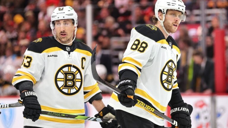 CHICAGO, ILLINOIS - DECEMBER 04: Brad Marchand #63 and David Pastrnak #88 of the Boston Bruins look on against the Chicago Blackhawks during the third period at the United Center on December 04, 2024 in Chicago, Illinois.