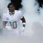 Miami Dolphins wide receiver Tyreek Hill (10) runs onto the field before an NFL football game against the New England Patriots, Sunday, Nov. 24, 2024, in Miami Gardens, Fla.