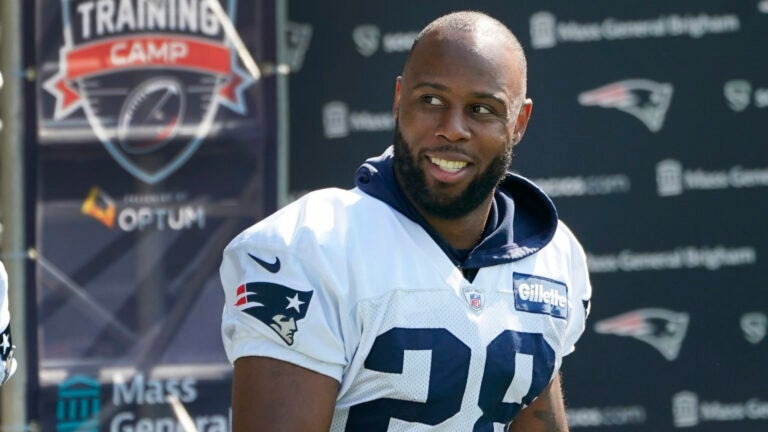 New England Patriots running back James White walks to an NFL football practice, Friday, July 30, 2021, in Foxborough, Mass.