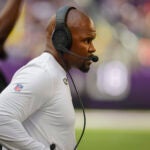Minnesota Vikings Defensive coordinator Brian Flores walks along the sidelines during the second half of an NFL football game with the Las Vegas Raiders Saturday, Aug. 10, 2024, in Minneapolis.