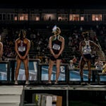 A transgender sprinter wears a trans flag in her hair at the 2024 NCAA Division III outdoor track and field championships.