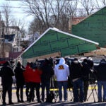 Members of the media observe the scene of a house collapse in Weymouth.