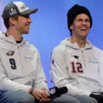Philadelphia Eagles' Nick Foles and New England Patriots' Tom Brady answer questions during NFL football Super Bowl 52 Opening Night Monday, Jan. 29, 2018, at the Xcel Center in St. Paul, Minn.