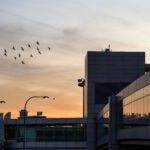 A Kansas woman died aboard an Air France flight to Logan Airport Tuesday evening, state police said.