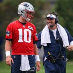 New England Patriots quarterback Mac Jones (10) and offensive coordinator Josh McDaniels during today’s team practice in Foxborough. -