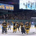 The Bruins are seen on the ice as well as the scoreboard as they salute the crowd following their victory. The Boston Bruins hosted the Pittsburgh Penguins in the Annual NHL Winter Classic outdoor hockey game at Fenway Park.