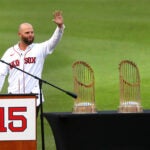 Before the game, a special ceremony was held to honor former Red Sox Dustin Pedroia. Pedroia waves to the crowd next to the World Series trophys he was a part of.