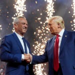 Republican presidential nominee former President Donald Trump shakes hands with Independent presidential candidate Robert F. Kennedy Jr.