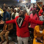 Jean-Michel Gisnel cries out while praying with other congregants.
