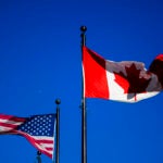 The flags of Canada and the United States.