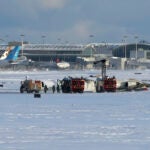 Pearson International Airport firefighters work on an upside down Delta Air Lines plane, which was heading from Minneapolis to Toronto when it crashed on the runway, in Toronto, Monday, Feb. 17, 2025.