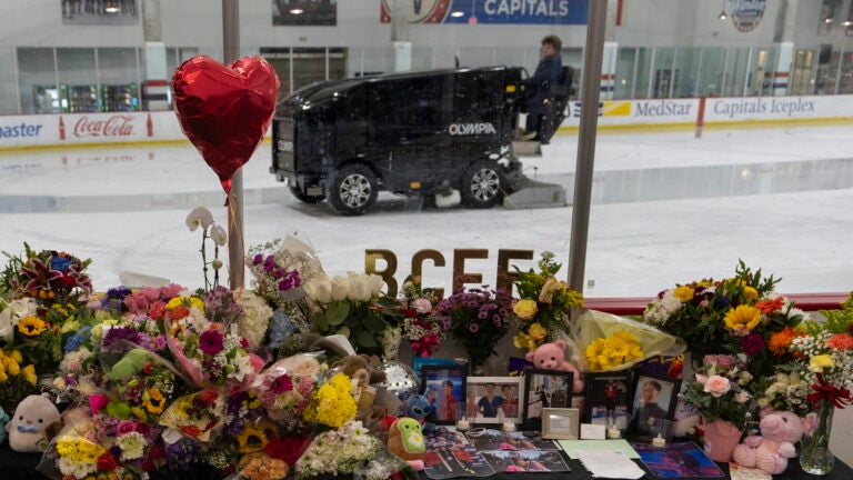 An ice resurfacer prepares the ice as a memorial is seen along the boards at MedStar Capitals Iceplex Sunday, Feb. 2, 2025, in Arlington, Va., for the figure skaters who were among the 67 victims of a mid-air collision between an Army helicopter and an American Airlines flight from Kansas.