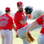 Newly signed Boston Red Sox pitcher Garrett Crochet (second from right) works out on the first day of spring training at JetBlue Park.