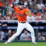 Houston Astros third baseman Alex Bregman throws to second after fielding a bunt by Detroit Tigers' Parker Meadows in the ninth inning of Game 2 of an AL Wild Card Series baseball game Wednesday, Oct. 2, 2024, in Houston.