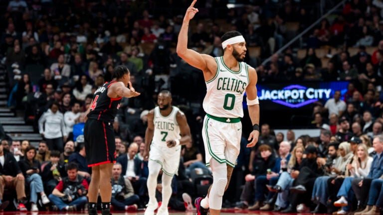 Boston Celtics forward Jayson Tatum reacts to scoring against the Toronto Raptors during the first half.