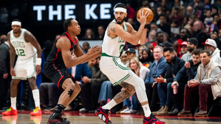 Boston Celtics forward Jayson Tatum plays the ball against Toronto Raptors forward Scottie Barnes during the first half.