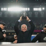 Philadelphia Eagles owner Jeffrey Lurie holds up the championship trophy after the Eagles won the NFC Championship NFL football game against the Washington Commanders, Sunday, Jan. 26, 2025, in Philadelphia.