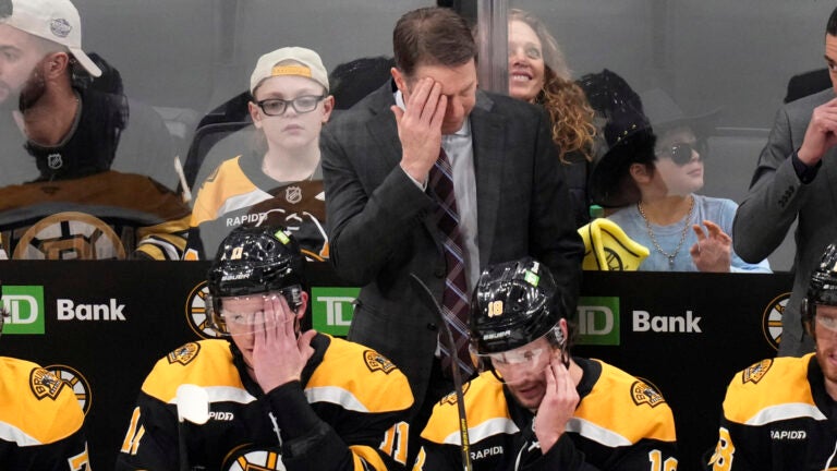 Boston Bruins interim coach Joe Sacco, cleans his forehead during the first period of a NHL hockey game against the Toronto Maple Leafs, on Tuesday, February 25, 2025, in Boston.