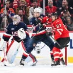 MONTREAL, CANADA - FEBRUARY 15: Charlie McAvoy #25 of Team USA and Sidney Crosby #87 of Team Canada battle for position during the third period in the 2025 NHL 4 Nations Face-Off at the Bell Centre on February 15, 2025 in Montreal, Quebec, Canada. Team USA defeated Team Canada 3-1.