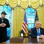 President Donald Trump listens as Elon Musk speaks in the Oval Office at the White House, Tuesday, Feb. 11, 2025, in Washington.