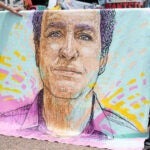FILE - A drawn portrait of Marc Fogel, who has been detained in Russia since August 2021, hangs on rails outside of the White House during a demonstration organized by his family, July 15, 2023, in Washington.