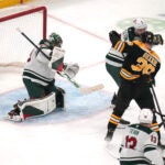 Bruins defenseman Charlie McAvoy scores on Minnesota Wild goaltender Marc-Andre Fleury, left, during the second period.