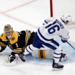 Toronto Maple Leafs right wing Mitch Marner scores past Boston Bruins goaltender Jeremy Swayman to win 5-4 in overtime at TD Garden.