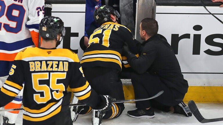 Bruins center Matthew Poitras was injured after being checked into the Islanders open bench door in the 2nd period.
