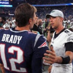 New England Patriots quarterback Tom Brady (12) gets together with Philadelphia Eagles quarterback Nick Foles (9) at the end of the game. The New England Patriots host the Philadelphia Eagles in the second pre-season home exhibition game at Gillette Stadium.