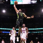 Celtics forward Jayson Tatum drives to the basket on a dunk against the Philadelphia 76ers during the first half.