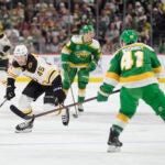 Bruins left wing Cole Koepke skates with the puck as Minnesota Wild center Gustav Nyquist follows during the second period.