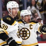 SUNRISE, FLORIDA - JANUARY 11: Morgan Geekie #39 of the Boston Bruins celebrates his powerplay goal against Sergei Bobrovsky #72 of the Florida Panthers at 6:02 of the first period and is joined by Brad Marchand #63 (r) at Amerant Bank Arena on January 11, 2025 in Sunrise, Florida.