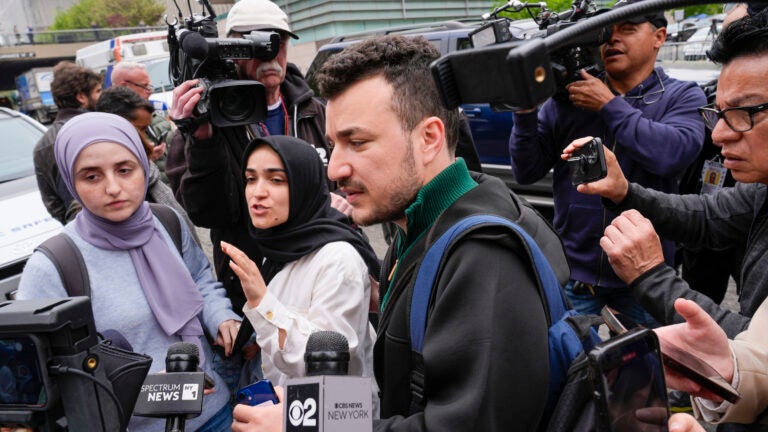 Members of the Columbia University Apartheid Divest group, including Sueda Polat, second from left, and Mahmoud Khalil, center, are surrounded by members of the media outside the Columbia University campus.