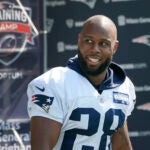 New England Patriots running back James White walks to an NFL football practice, Friday, July 30, 2021, in Foxborough, Mass.