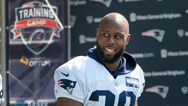 New England Patriots running back James White walks to an NFL football practice, Friday, July 30, 2021, in Foxborough, Mass.