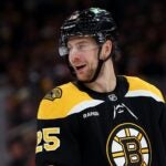 BOSTON, MASSACHUSETTS - DECEMBER 21: Brandon Carlo #25 of the Boston Bruins looks on during the second period against the Buffalo Sabres at TD Garden on December 21, 2024 in Boston, Massachusetts.