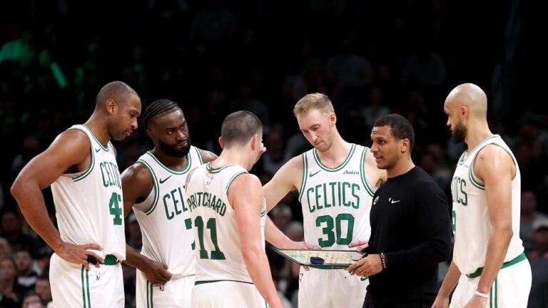 Boston Celtics head coach Joe Mazzulla stands in a huddle with Al Horford #42, Jaylen Brown #7, Payton Pritchard #11, Sam Hauser #30 and Derrick White #9 during the second half of the game against the Portland Trail Blazers at TD Garden on March 05, 2025 in Boston