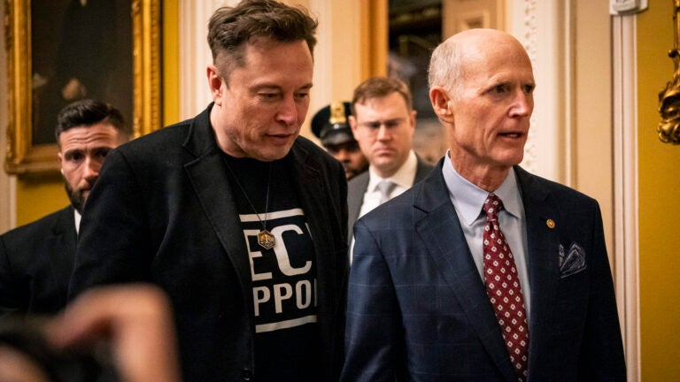 Elon Musk, left, walks with Sen. Rick Scott (R-Fla.) to a Senate Republican luncheon on Capitol Hill in Washington, on Wednesday, March 5, 2025.
