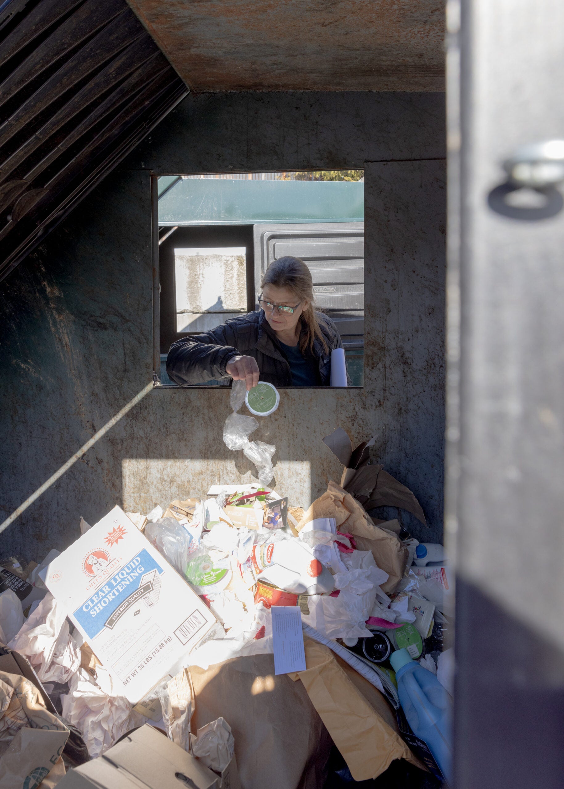 Heather Billings inspects for food waste.