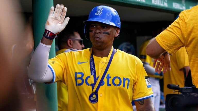 Boston Red Sox third base Rafael Devers (11) is congratulated in the Sox dugout after his solo home run during the fifth inning. - The Boston Red Sox host the Kansas City Royals in a MLB game Saturday, July 13, 2024 at Fenway Park in Boston, MA.