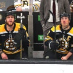 There was a wide space and no chatting betwenn Boston Bruins right wing David Pastrnak (88) (left) and Boston Bruins left wing Brad Marchand (63) on the bench in the 3rd period.