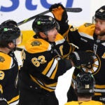 .Boston Bruins left wing Brad Marchand (63)(enter) is congratulated by Boston Bruins defenseman Charlie McAvoy (73) (left) and Boston Bruins right wing David Pastrnak (88) after Marchand’s 1st period goal.