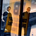The Boston Bruins held practice at Warrior Ice Arena under their new coach, Joe Sacco after Jim Montgomery was fired as the head coach. Bruins GM Don Sweeney(left) and Bruins president Cam Neely watch the practice from Sweeney’s office above the ice.