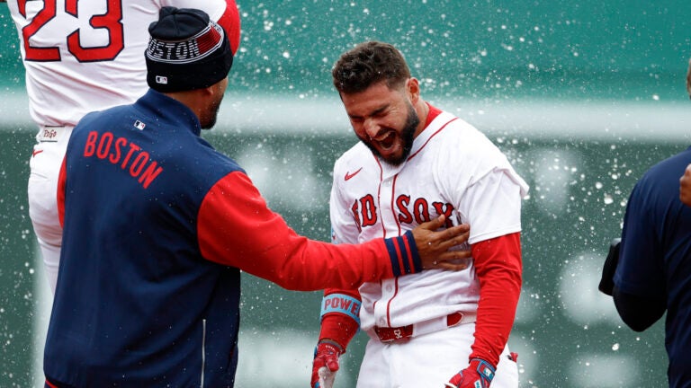 Boston Red Sox outfielder Wilyer Abreu (52) is showered with water after his walk off RBI in the tenth inning, defeating the St. Louis Cardinals 5-4 at Fenway Park.