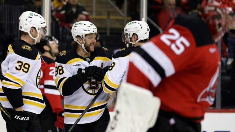 Bruins right wing David Pastrnak celebrates with Elias Lindholm after scoring a goal past New Jersey Devils goaltender Jacob Markstrom in the first period.