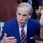FILE - Texas Gov. Greg Abbott talks in the East Room of the White House, Feb. 5, 2025, in Washington.