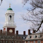 Spring buds appear on a tree near Eliot House, rear, at Harvard University, Tuesday, April 15, 2025, in Cambridge, Mass.