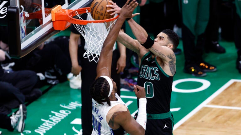 Celtics forward Jayson Tatum dunks over Orlando Magic center Wendell Carter Jr. (34) to end the second quarter in game five of the NBA Eastern Conference playoffs at TD Garden.