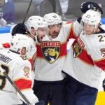 Florida Panthers defenseman Nate Schmidt (88), defenseman Uvis Balinskis (26), forward Brad Marchand (63) and forward Eetu Luostarinen (27) celebrate after a goal against the Toronto Maple Leafs during the third period of Game 1 in an NHL hockey second-round playoff series in Toronto, Monday, May 5, 2025.