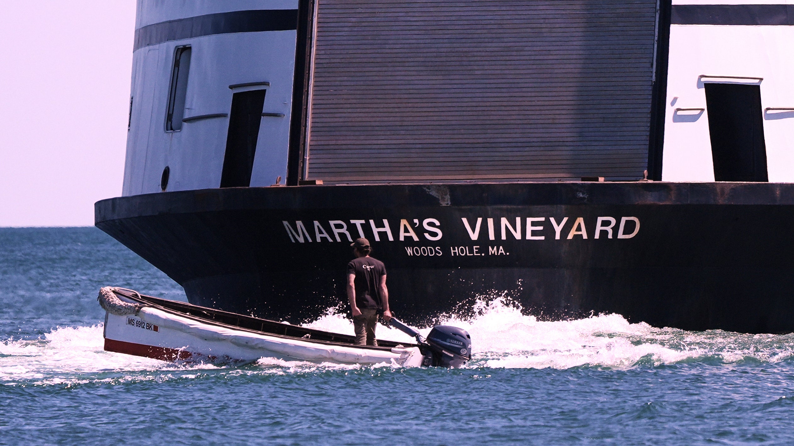 A man navigates the wake behind the Martha's Vineyard Ferry. 